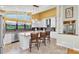 Beautiful kitchen featuring granite countertops, white cabinets, and a large island with seating at 2287 Demaret Dr, Dunedin, FL 34698