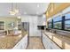 Spacious kitchen with granite countertops, white cabinets, and stainless steel appliances at 2287 Demaret Dr, Dunedin, FL 34698