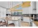 Modern kitchen with granite countertops, white cabinets, and stainless steel appliances at 2287 Demaret Dr, Dunedin, FL 34698