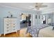 Light-filled primary bedroom with hardwood floors and sliding door access to an outdoor seating area at 2287 Demaret Dr, Dunedin, FL 34698