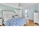 Light-filled primary bedroom with hardwood floors and an ensuite bathroom at 2287 Demaret Dr, Dunedin, FL 34698