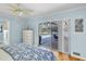 Light-filled primary bedroom with hardwood floors and sliding door access to the pool area at 2287 Demaret Dr, Dunedin, FL 34698