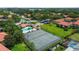 Aerial view of a community with tennis courts, pool and parking at 2412 Hammock Pine Blvd, Clearwater, FL 33761