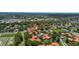 Aerial view of a condo neighborhood surrounded by lush greenery and ponds at 2412 Hammock Pine Blvd, Clearwater, FL 33761