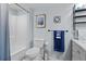 Well-maintained bathroom features a shower, toilet, vanity, and decorative shelving for convenient storage and style at 2412 Hammock Pine Blvd, Clearwater, FL 33761