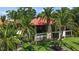 Beautiful exterior view of condo with tropical landscaping and balcony at 2412 Hammock Pine Blvd, Clearwater, FL 33761