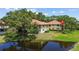 Scenic exterior of the condo building overlooking a tranquil pond at 2412 Hammock Pine Blvd, Clearwater, FL 33761