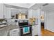 Modern kitchen featuring granite countertops, updated appliances, backsplash, and an open flow to the dining and living area at 2412 Hammock Pine Blvd, Clearwater, FL 33761