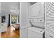 Convenient laundry area with a stacked washer and dryer unit located near the bedroom for easy access at 2412 Hammock Pine Blvd, Clearwater, FL 33761