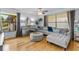 Comfortable living room showcasing a plush sectional, stylish mirrored furniture, hardwood flooring, and a relaxing ambiance at 2412 Hammock Pine Blvd, Clearwater, FL 33761