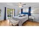 Bright main bedroom with a private balcony, stylish furnishings, and soft natural light creating a relaxing retreat at 2412 Hammock Pine Blvd, Clearwater, FL 33761