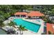 Aerial view of a community pool and cabana area with a hot tub and plenty of space for residents to relax and enjoy at 2412 Hammock Pine Blvd, Clearwater, FL 33761