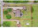 Overhead view of home showcasing its spacious lot, driveway, pool, and proximity to surrounding greenery and streets at 2502 Fritzke Rd, Dover, FL 33527