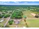 Aerial view of property showcasing the spacious lot, home, pool, and surrounding landscape with mature trees at 2502 Fritzke Rd, Dover, FL 33527