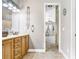 Well-lit bathroom boasts double vanity, ample storage, decorative mirror, and tile floors at 2502 Fritzke Rd, Dover, FL 33527