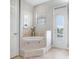 Bright bathroom features a tiled soaking tub with steps, window with blinds, and outdoor access at 2502 Fritzke Rd, Dover, FL 33527