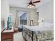 Comfortable bedroom with ceiling fan, natural light, and a cozy bed offers a relaxing retreat at 2502 Fritzke Rd, Dover, FL 33527