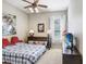 Inviting bedroom with ceiling fan, natural light, and a cozy plaid bed perfect for relaxation at 2502 Fritzke Rd, Dover, FL 33527