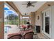 Comfortable covered patio with ceiling fans, furniture, and views of the pool and backyard at 2502 Fritzke Rd, Dover, FL 33527