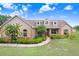 Beautiful home with well-maintained landscaping, including colorful flower beds and lush greenery, enhancing its curb appeal at 2502 Fritzke Rd, Dover, FL 33527