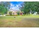 Charming single-Gathering home with mature trees, green grass, and a welcoming front entrance at 2502 Fritzke Rd, Dover, FL 33527