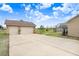 View of the home's two-car garage with a wide driveway and screened-in patio area, perfect for outdoor enjoyment at 2502 Fritzke Rd, Dover, FL 33527