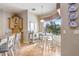 Sunlit kitchen nook features tile floors, table and chairs, and a large window with a view of the outdoors at 2502 Fritzke Rd, Dover, FL 33527