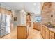Spacious kitchen with stainless steel appliances, custom cabinets, and granite countertops at 2502 Fritzke Rd, Dover, FL 33527