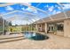 Backyard pool and hot tub with large screened lanai and brick-paved patio at 2502 Fritzke Rd, Dover, FL 33527
