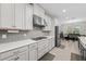 Modern kitchen with stainless steel appliances, light gray cabinets and hexagonal backsplash at 2512 High Tides Way, Wesley Chapel, FL 33543