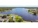 Beautiful aerial view of a lakefront community with a pool, lush greenery, and stunning blue waters at 2557 Cedar Cypress Ct, Tampa, FL 33618