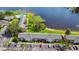 An aerial view shows a charming community with a pool adjacent to a beautiful lake at 2557 Cedar Cypress Ct, Tampa, FL 33618