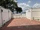 An outdoor brick patio with a white picket fence offering views of the water at 2557 Cedar Cypress Ct, Tampa, FL 33618