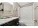 Functional bathroom featuring a tub with shower, vanity, and a built-in storage with a decorative mirror at 2557 Cedar Cypress Ct, Tampa, FL 33618