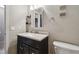 Close-up of a neat bathroom with a vanity, mirror, lighting, and essential fixtures, like a toilet and towel rack at 2557 Cedar Cypress Ct, Tampa, FL 33618