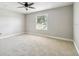Comfortable bedroom with plush carpeting, a ceiling fan, and a large window at 2557 Cedar Cypress Ct, Tampa, FL 33618
