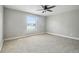 Spacious bedroom with neutral colors, carpet flooring, and scenic outside view at 2557 Cedar Cypress Ct, Tampa, FL 33618