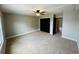 This bedroom features neutral carpet, ceiling fan, and a closet at 2557 Cedar Cypress Ct, Tampa, FL 33618