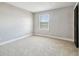 Cozy bedroom with neutral carpeting, trim and a window with natural light at 2557 Cedar Cypress Ct, Tampa, FL 33618