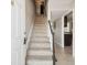Inviting entryway with a staircase and view into the kitchen, showcasing a bright and welcoming interior at 2557 Cedar Cypress Ct, Tampa, FL 33618