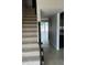 Bright entryway features tiled flooring, staircase, and view of the back patio and waterfront at 2557 Cedar Cypress Ct, Tampa, FL 33618