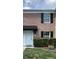 Charming brick townhome featuring a white door, tidy landscaping, and classic black shutters at 2557 Cedar Cypress Ct, Tampa, FL 33618