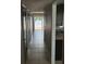 Inviting hallway leading to a sliding glass door with serene water views and an outdoor patio at 2557 Cedar Cypress Ct, Tampa, FL 33618