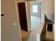 Hallway view showing neutral carpet, a dark paneled door and access to the stairway at 2557 Cedar Cypress Ct, Tampa, FL 33618