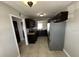 Well-lit kitchen featuring dark cabinetry, stainless steel appliances and neutral countertops at 2557 Cedar Cypress Ct, Tampa, FL 33618
