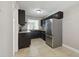 Modern kitchen showcases stainless steel appliances, dark wood cabinets, and tile flooring at 2557 Cedar Cypress Ct, Tampa, FL 33618