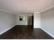 Spacious living room featuring wood floors and a kitchen view through passthrough at 2557 Cedar Cypress Ct, Tampa, FL 33618