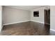Open living area with wood-look flooring and a pass-through window to the kitchen at 2557 Cedar Cypress Ct, Tampa, FL 33618