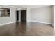 Bright living room with wood-look floors and pass-through view into kitchen at 2557 Cedar Cypress Ct, Tampa, FL 33618