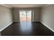 Bright living room with wood floors, sliding glass doors to brick patio, and calming natural light at 2557 Cedar Cypress Ct, Tampa, FL 33618
